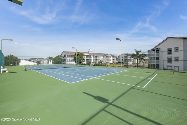 view of sport court featuring fence