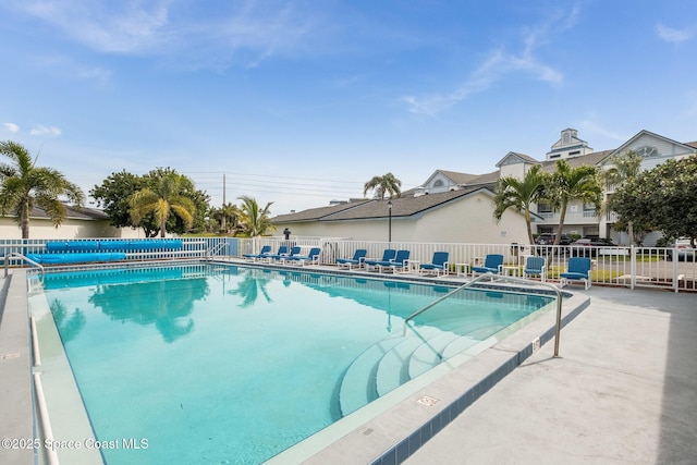 community pool featuring a patio and fence