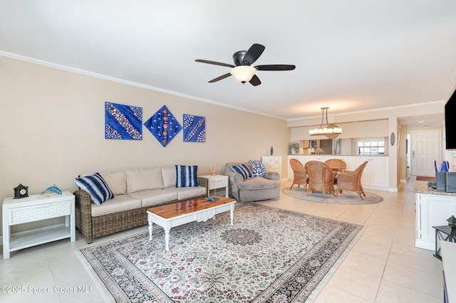 living area featuring light tile patterned flooring, ceiling fan with notable chandelier, and ornamental molding