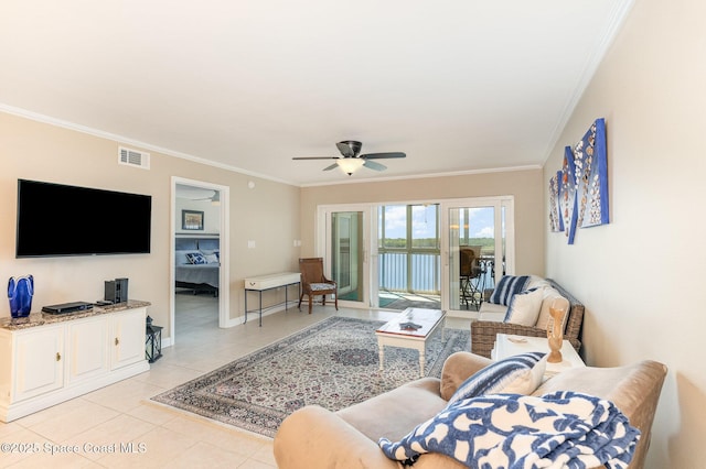 living room featuring light tile patterned flooring, baseboards, visible vents, and ornamental molding