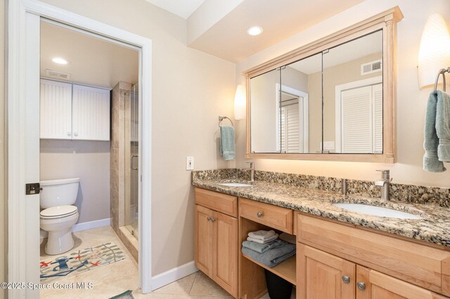 bathroom featuring tile patterned floors, visible vents, toilet, and a sink