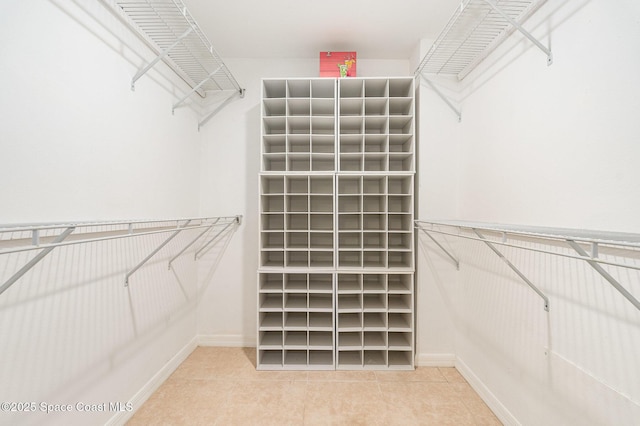 spacious closet featuring tile patterned floors