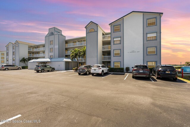 property at dusk with uncovered parking