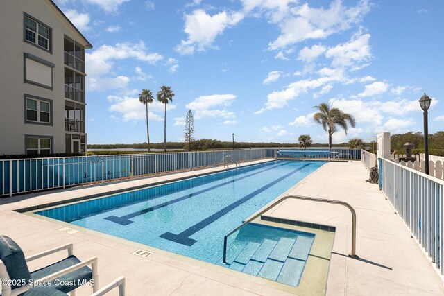 pool featuring a patio area and fence