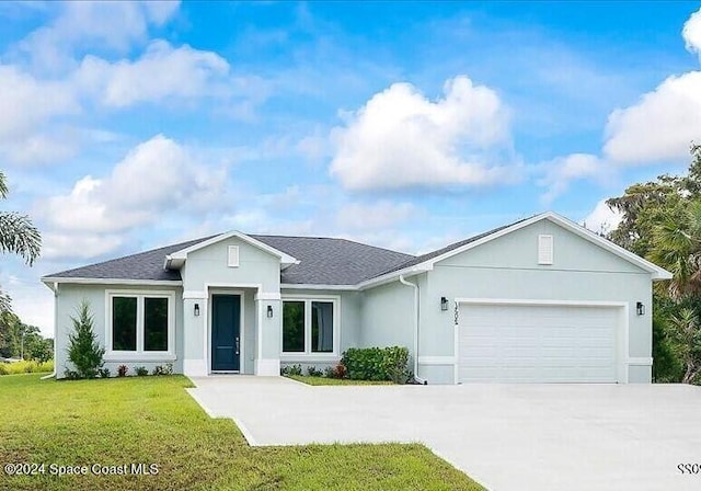 view of front of house with roof with shingles, stucco siding, a front lawn, concrete driveway, and a garage