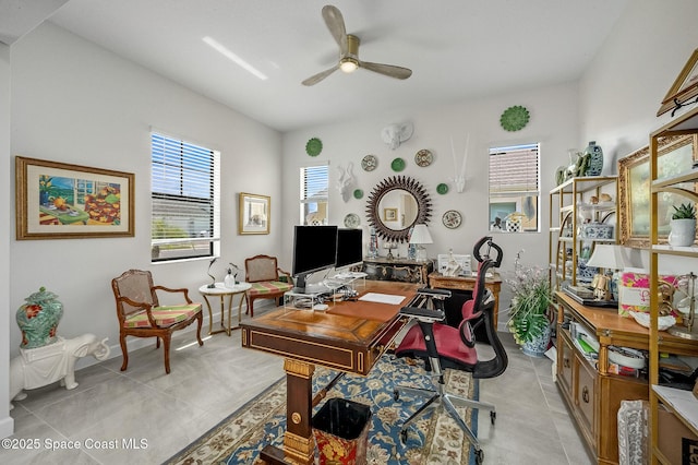 office featuring light tile patterned floors, baseboards, and a ceiling fan