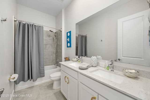 bathroom featuring double vanity, tile patterned floors, shower / tub combo with curtain, and a sink