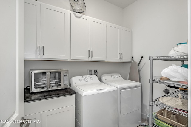 clothes washing area with cabinet space, a toaster, and independent washer and dryer