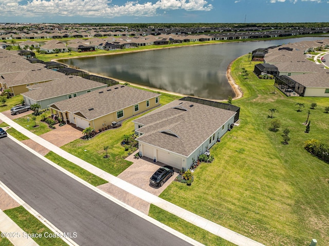 drone / aerial view featuring a residential view and a water view