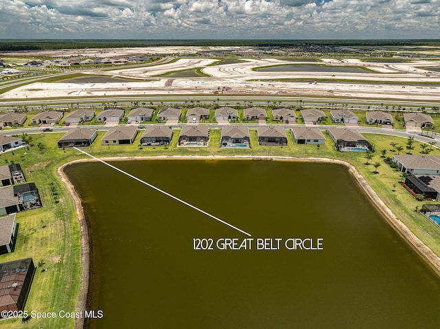 drone / aerial view with a residential view and a water view