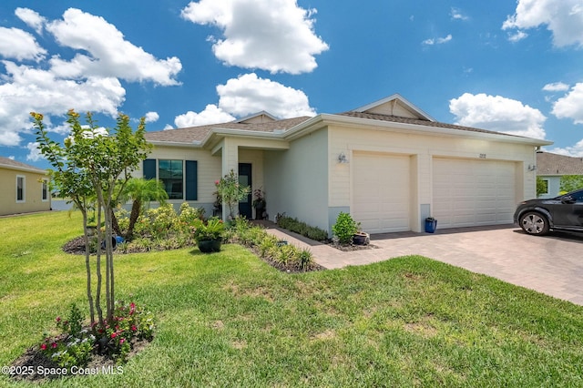 ranch-style home with decorative driveway, a front lawn, and an attached garage