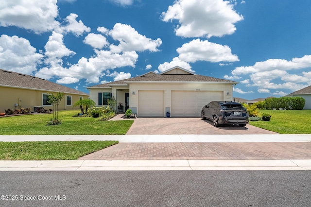 view of front facade featuring a front lawn, decorative driveway, and an attached garage