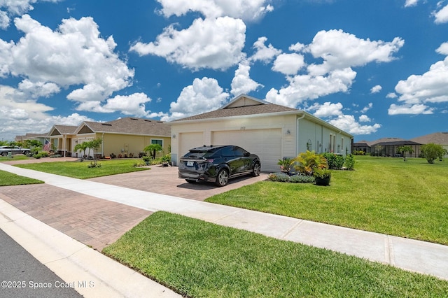 ranch-style home with stucco siding, an attached garage, decorative driveway, and a front yard