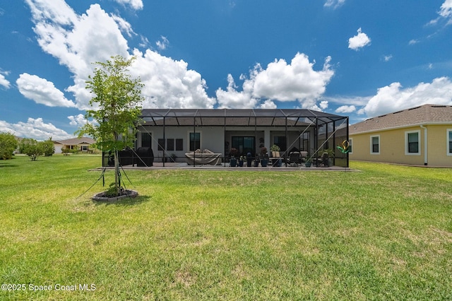 back of house with a lanai, a lawn, and a patio