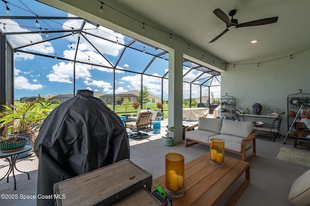 view of patio / terrace with glass enclosure, ceiling fan, outdoor lounge area, and grilling area