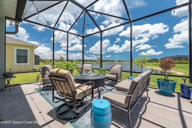 view of patio featuring glass enclosure and a water view