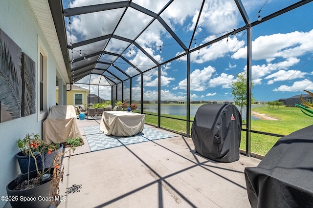 sunroom featuring vaulted ceiling and a water view