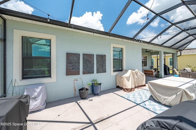 rear view of property featuring outdoor lounge area, a patio, a ceiling fan, and a lanai