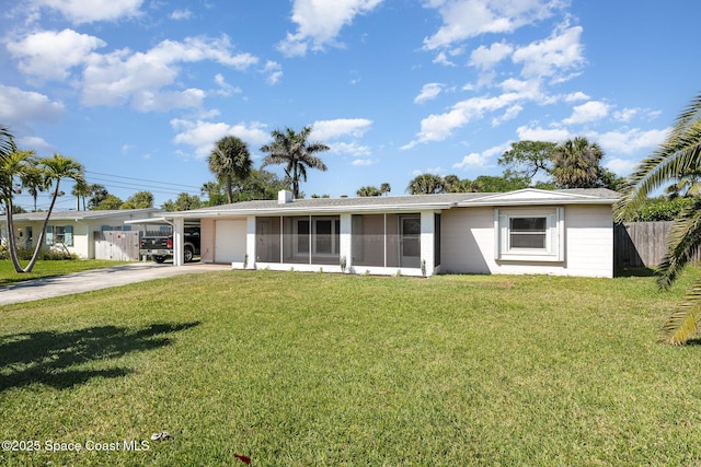 single story home featuring driveway, a sunroom, a front lawn, and fence