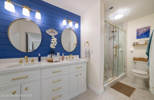 full bath featuring visible vents, toilet, double vanity, a stall shower, and a sink