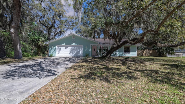 ranch-style home featuring driveway, a front lawn, a garage, and fence