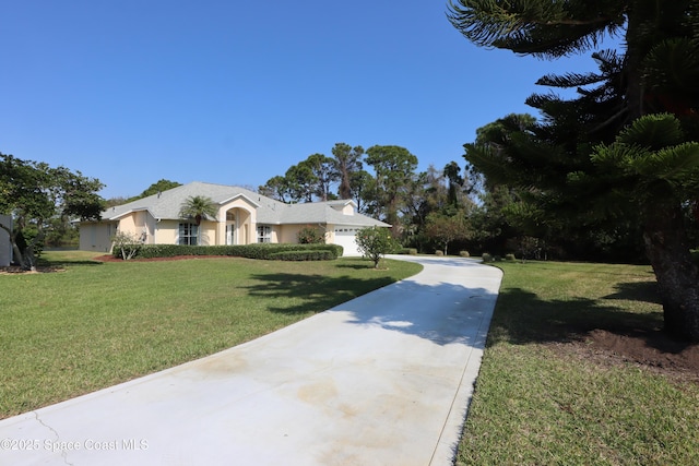 view of front of home with a front lawn, concrete driveway, a garage, and stucco siding