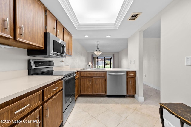 kitchen featuring stainless steel appliances, crown molding, light countertops, light tile patterned floors, and a raised ceiling