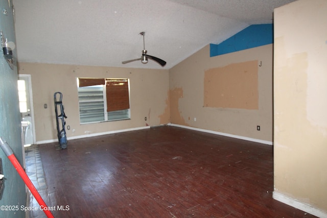 unfurnished room with ceiling fan, baseboards, lofted ceiling, and hardwood / wood-style flooring