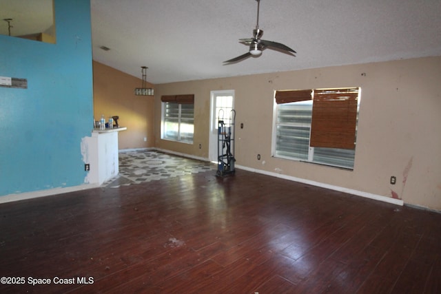 unfurnished living room featuring ceiling fan, baseboards, lofted ceiling, and wood finished floors