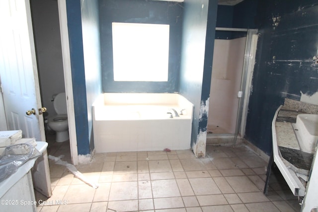 full bath featuring vanity, a stall shower, a garden tub, toilet, and tile patterned floors