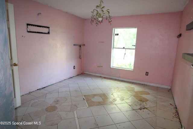 unfurnished dining area featuring a chandelier