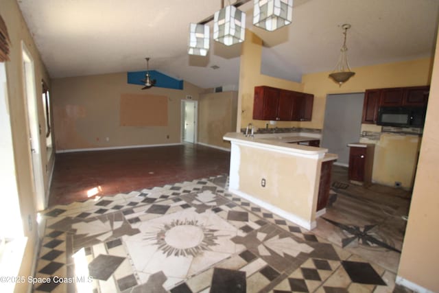 kitchen with hanging light fixtures, open floor plan, lofted ceiling, and black microwave