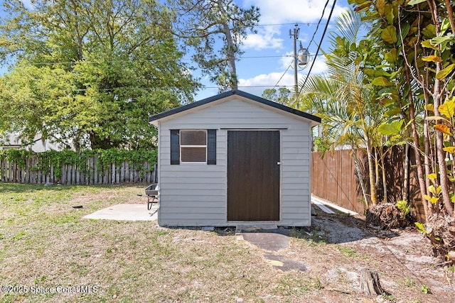 view of shed featuring a fenced backyard