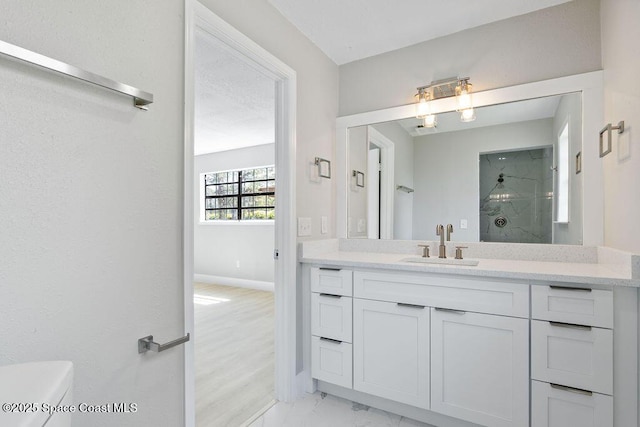 full bath featuring vanity, baseboards, walk in shower, toilet, and marble finish floor