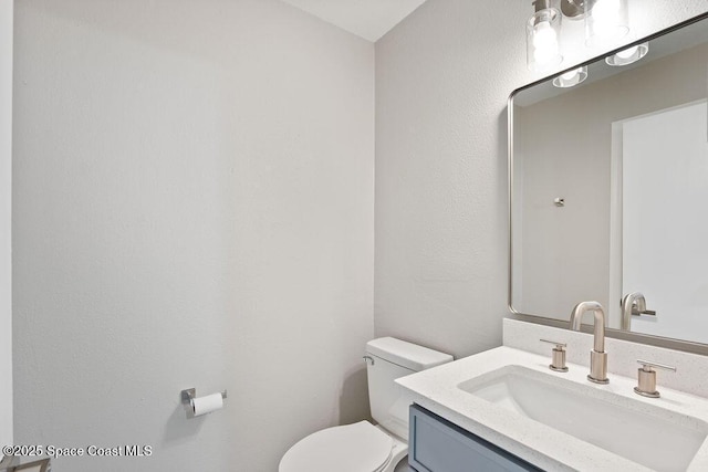 half bathroom with toilet and vanity