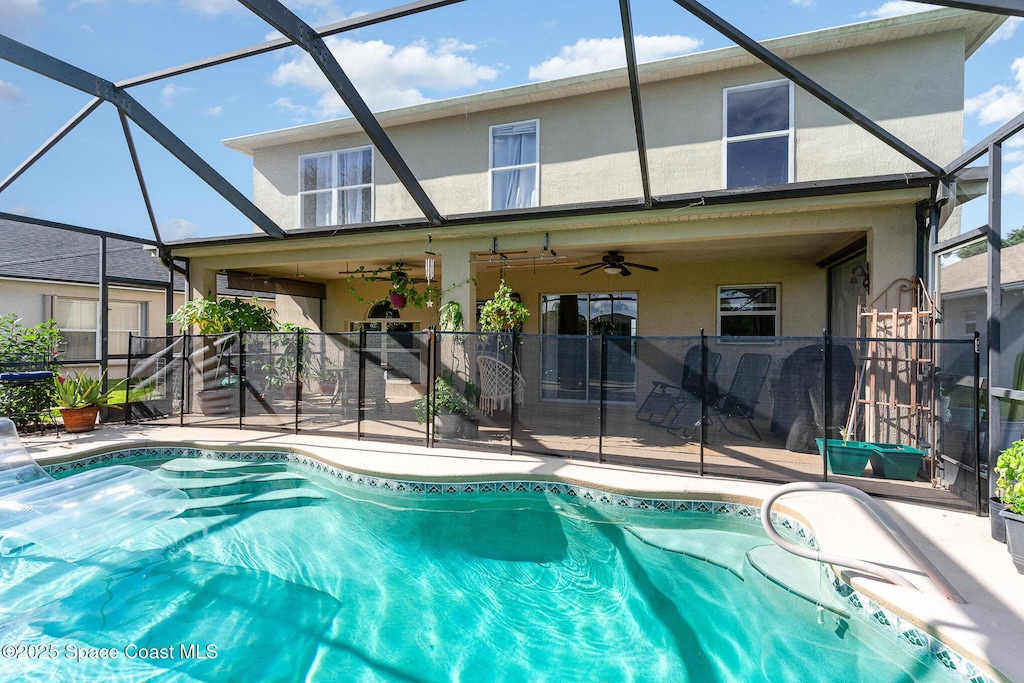 view of swimming pool featuring a patio and a lanai