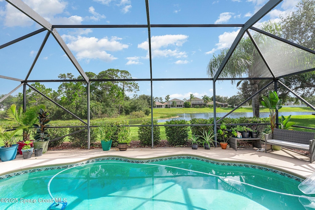 pool with a water view, a lanai, and a patio area