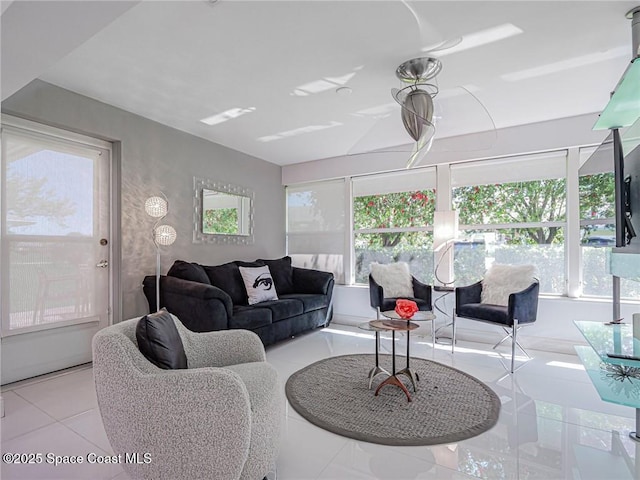 living room featuring tile patterned flooring and a healthy amount of sunlight