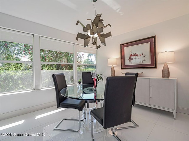 dining area with light tile patterned floors and baseboards