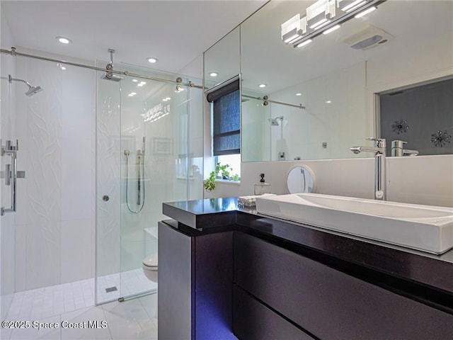 full bathroom with vanity, recessed lighting, a stall shower, tile patterned flooring, and toilet