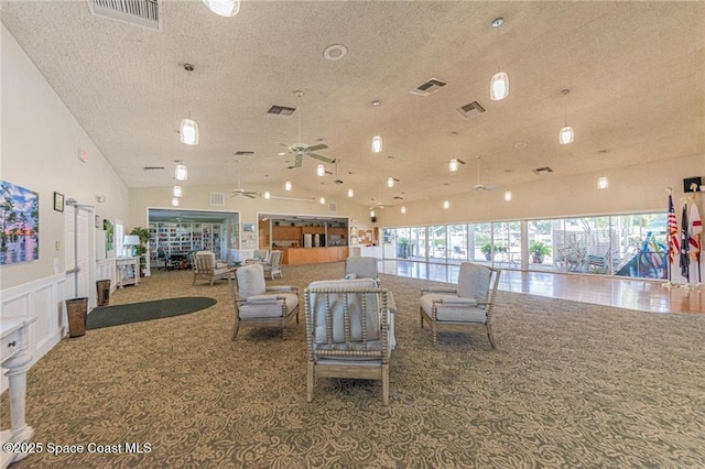 living room featuring visible vents, plenty of natural light, and carpet