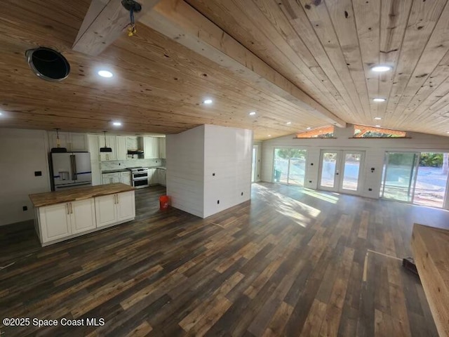 kitchen with butcher block countertops, open floor plan, appliances with stainless steel finishes, wood ceiling, and dark wood-style flooring