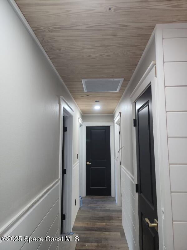 2275 Pineapple Pl, Merritt Island, FL 32952 - hall with wood ceiling, visible vents, dark wood-style floors, and wainscoting