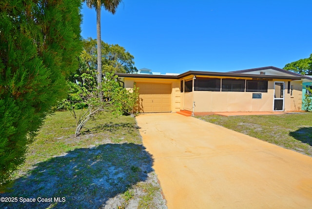 view of front of home featuring stucco siding, driveway, and an attached garage