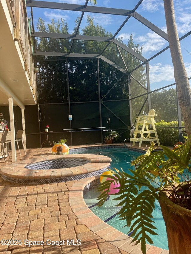 view of swimming pool with a patio area and glass enclosure