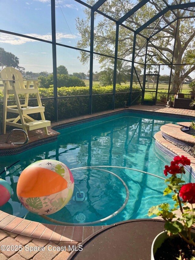 pool featuring a lanai and a patio