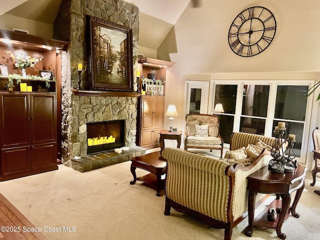 carpeted living room featuring high vaulted ceiling and a stone fireplace