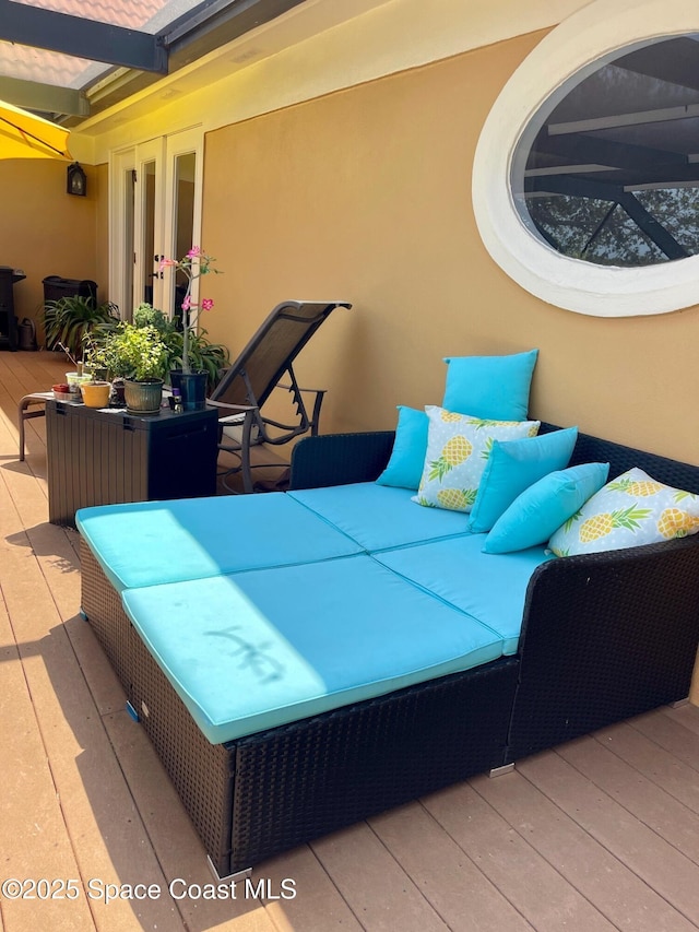 wooden terrace featuring outdoor lounge area