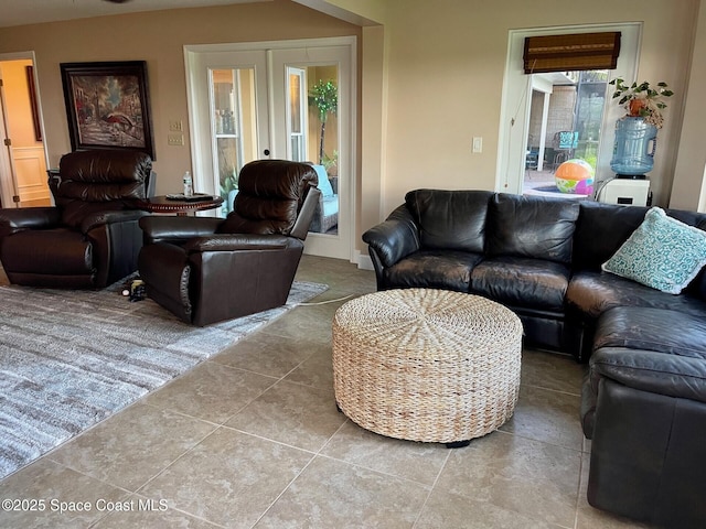 living area featuring tile patterned floors and french doors