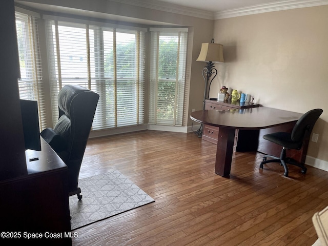 office featuring baseboards, hardwood / wood-style floors, and crown molding